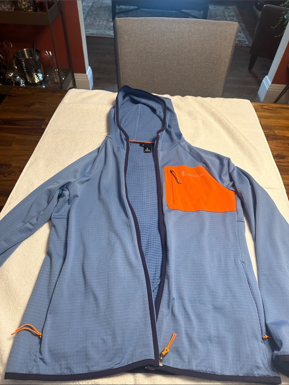 Cotopaxi Light Blue Hooded Jacket with Orange Chest Pocket